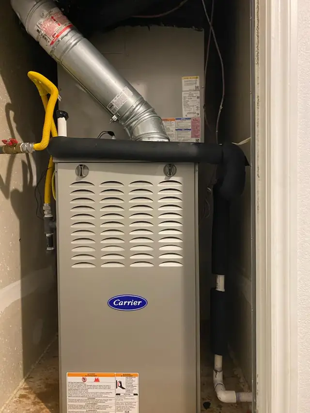 Carrier gas furnace installed in a closet with flue and flexible gas connector