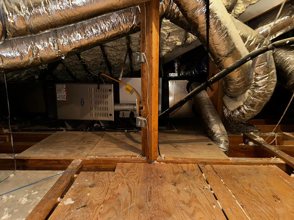 Cypress attic under a spray foam roof deck with two Carrier units and insulated trunk lines