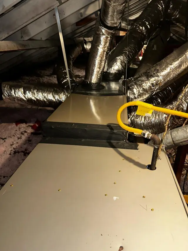 Sealed attic plenum with a yellow flexible gas line run alongside it